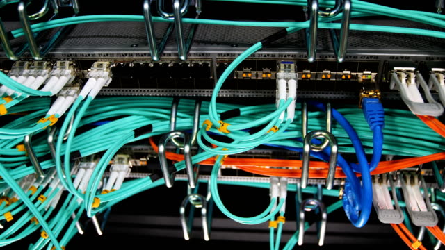 closeup-motion-along-mining-farm-servers-with-cables