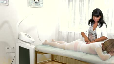 The-woman-enjoys-vacuum-roller-massage-in-beauty-salon