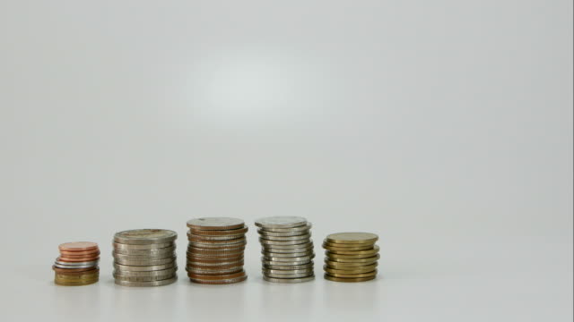 Growing-stacks-of-coins-on-white-background