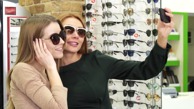 Gorgeous-happy-women-taking-selfies-while-shopping-eyewear