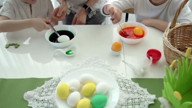Happy-easter!-mother-and-children-having-fun-paint-and-decorate-eggs-for-holiday