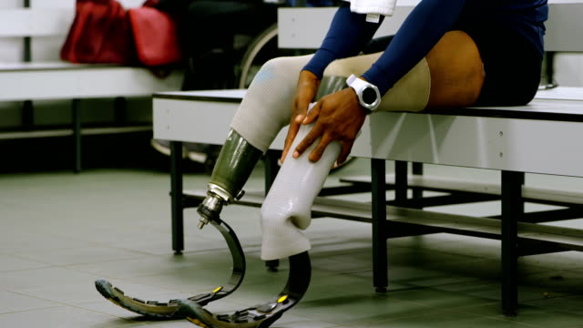 Two-disabled-athletics-relaxing-in-changing-room-4k