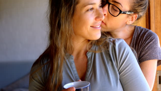 Lesbian-couple-embracing-each-other-at-home-4k
