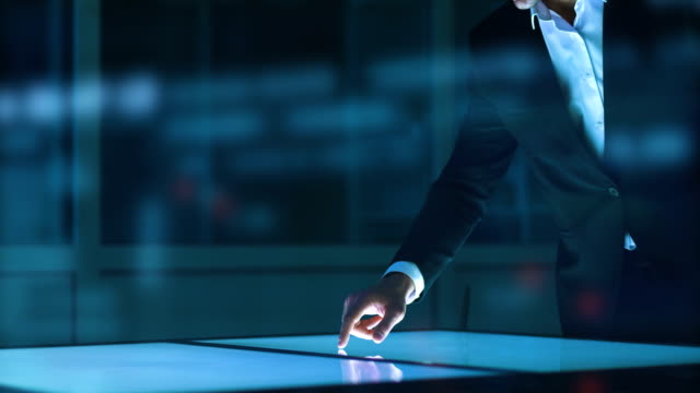 Der-Geschäftsmann-arbeiten-mit-einem-Sensor-Bildschirm-auf-einem-Hologramm-Hintergrund