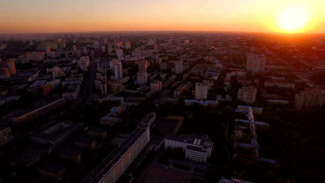 Green-city-on-the-background-of-a-beautiful-sunset-aerial