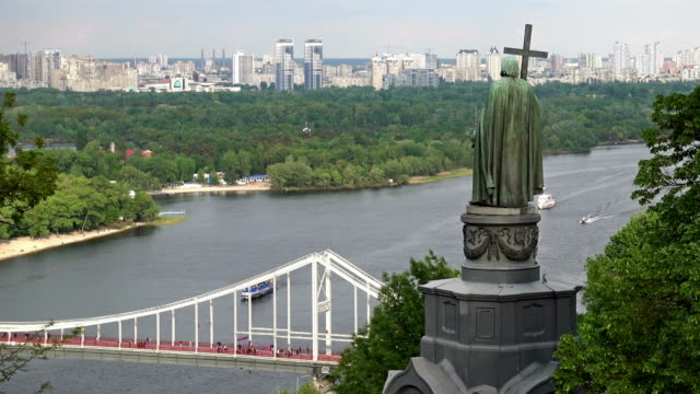 View-of-the-Dnieper-River,-the-Pedestrian-Bridge-and-the-Monument-to-Saint-Vladimir-from-Vladimir-Hill-in-Kiev