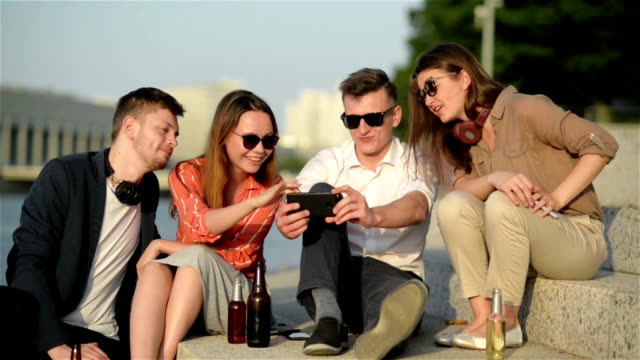 Group-Of-Students-Having-Fun-Together-With-Smartphones.-Closeup-Of-Hands-Social-Networking-With-Mobile-Phone-Online.-Technology-And-Phone-Addiction-Concept