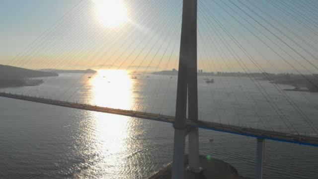 Aerial-shot-of-the-Russkiy-cable-bridge-during-sunset-in-a-city-of-Vladivostok,-Russia