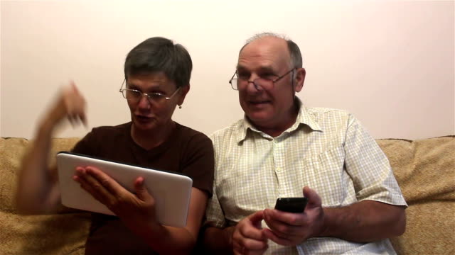 Attractive-adult-woman-and-adult-man-make-a-video-call-with-their-family-on-a-tablet-pc.