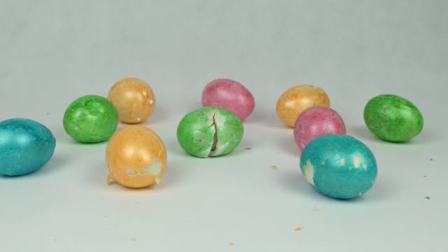 Broken-and-broken-multicolored-easter-eggs-on-white-background,-easter-holiday-graduation-concept,-decorated