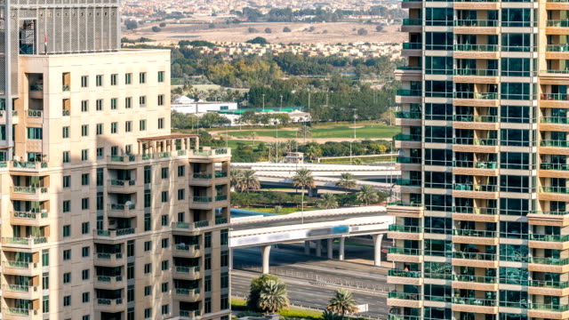 Golf-field-timelapse-from-top-at-day-time-with-traffic-on-sheikh-zayed-road