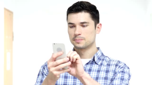 Man-Using-Smartphone-in-Office