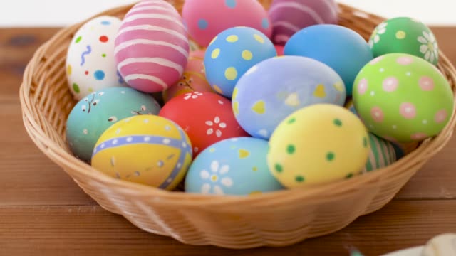 easter-eggs-in-basket-and--plate-with-cutlery-on-table