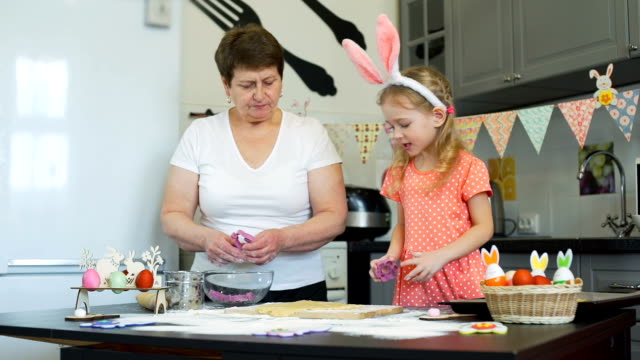 Girl-with-her-Grandma-Baking-Cookies-on-Easter