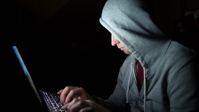 Anonymous-Hooded-Hacker-Programming-in-Computer-Console-Breaking-Password