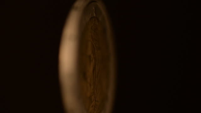 One--Euro-Coin-Rotating-on-a-black-background.