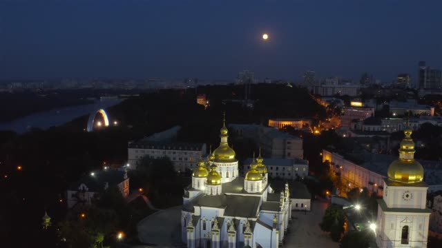 Aerial-view-of-St.-Andrew's-Church,-Ministry-of-Foreign-Affairs,-St.-Michael's-Cathedral-at-night-with-a-full-moon
