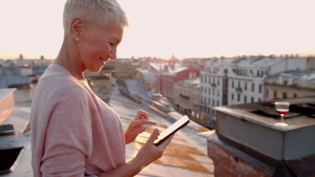 Woman-with-Short-Haircut-Using-Phone-on-Roof