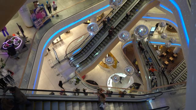Kiev,-Ukraine,-Europe---October-2019:-Central-Shopping-Center.-Many-people-ride-multiple-excavators-at-the-same-time.-A-lot-of-reflective-balls.-A-lot-of-disco-balls.