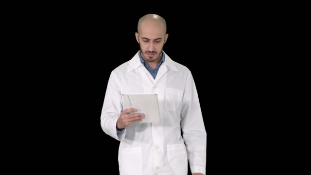 Mature-male-doctor-holding-digital-tablet-using-it-and-walking,-Alpha-Channel