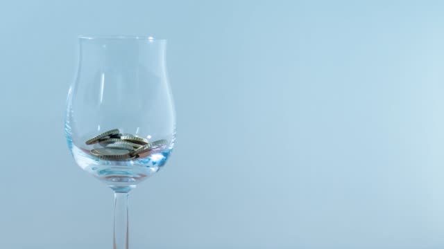 Coins-fill-glass-goblet-in-stop-motion