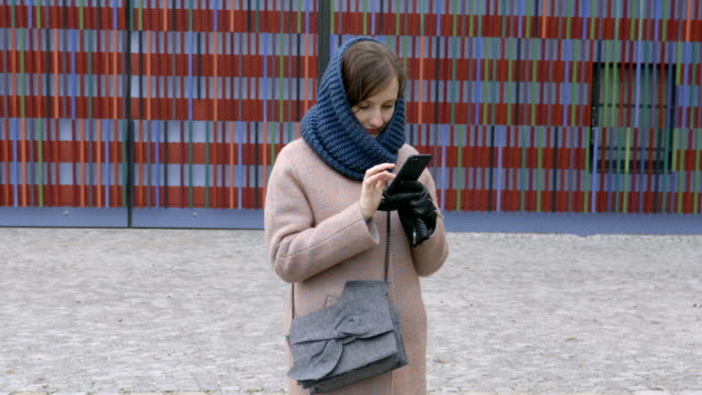 Girl-texting-message-on-smartphone-outside