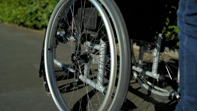 Tracking-shot-of-a-wheelchair-in-the-park