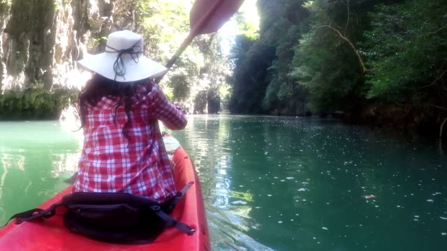 Woman-Exploring-Beautiful-Lagoon-On-Kayak-Boat-Action-Camera-POV-Of-Girl-Paddling