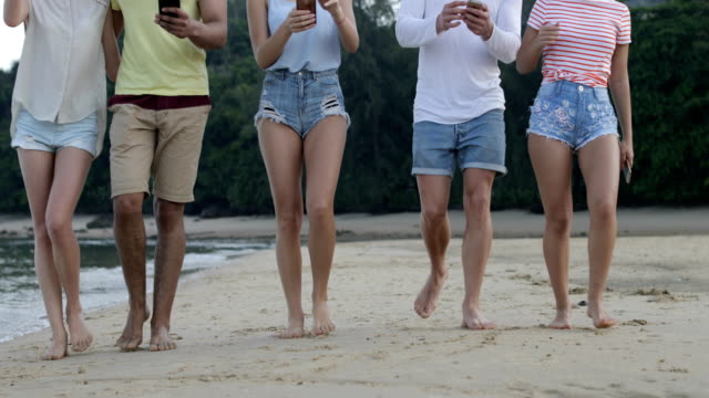 Passanten-am-tropischen-Strand-mit-Smart-Phones,-Touristen-Zellgruppe-Networking-Online