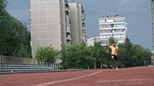 Paralympic-Athlete-Running-on-Stadium-towards-Camera