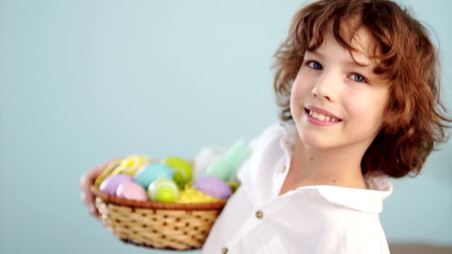 Cute-little-boy-with-an-Easter-basket-smiling-looking-at-the-camera
