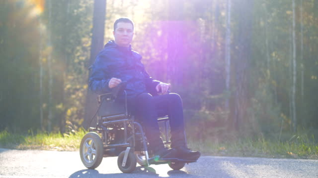 A-disabled-man-sits-and-looks-at-camera.