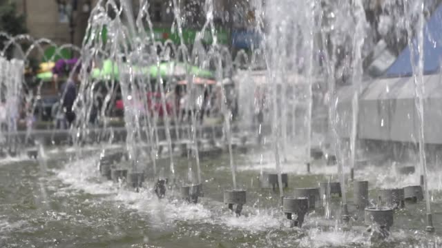 The-fountain-in-the-city-is-close-up.-Water-jets-slowed-down.-City-street-summer