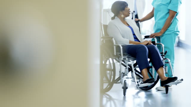 Multi-étnicos-equipo-senior-paciente-en-silla-de-ruedas