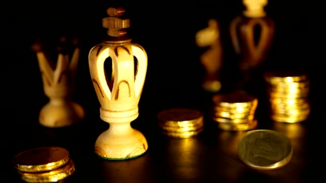 Chess-and-stack-of-coins-in-concept-of-money-power-or-saving-money,-financial-growth,-strategy-investment,-retirement
