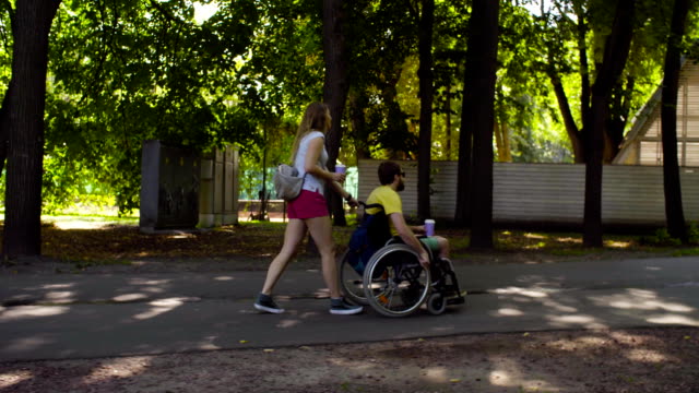 Young-disable-man-on-a-walk-in-the-park-with-his-wife
