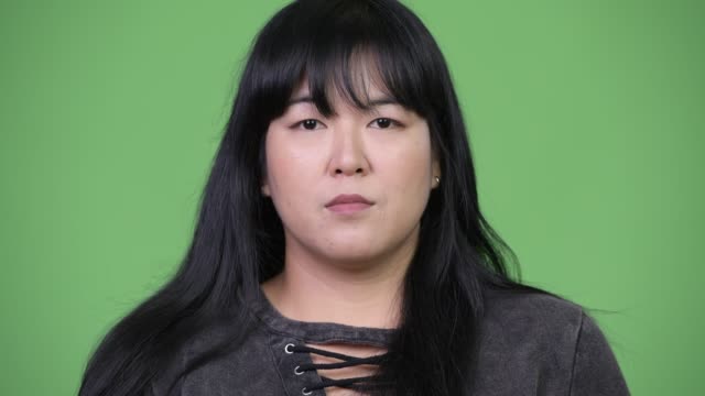 Head-shot-of-beautiful-overweight-Asian-woman-smiling