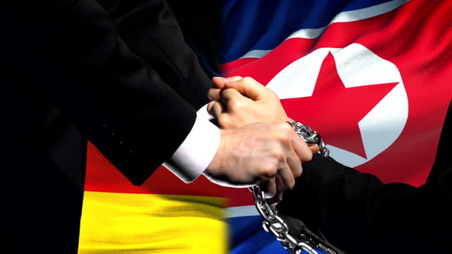 Germany-sanctions-North-Korea,-chained-arms,-political-or-economic-conflict