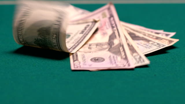 Venturous-person-throwing-big-sum-of-dollars-on-gaming-table,-large-money-bets