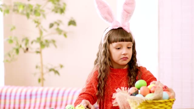 the-girl-considers-Easter-eggs-in-the-basket.