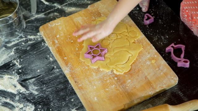 Little-Girl-Cutting-Easter-Cookies-on-a-Dough