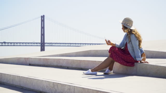 Woman-with-phone-on-seafront