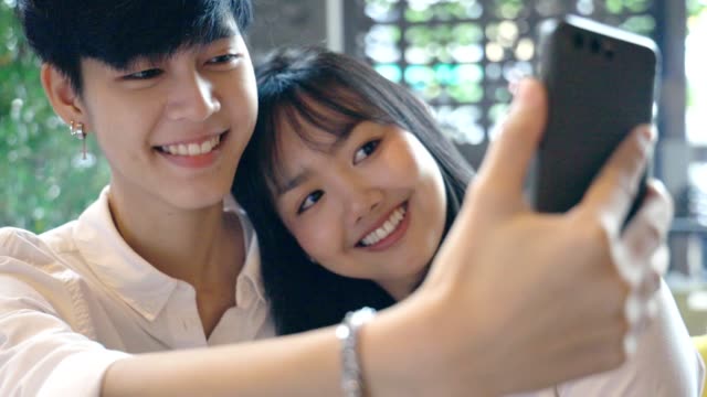 Lesbian-Asian-Couple-Taking-a-Selfie-Together,-LGBT-Concept-Slow-motion