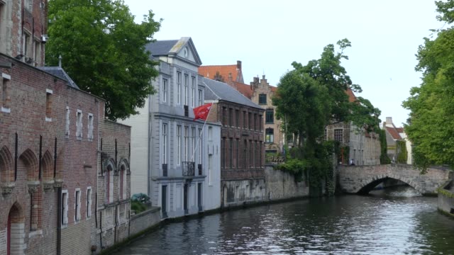 Bruges,-Belgium---May-2019:-View-of-the-water-channel-in-the-city-center.-Boat-trip-along-the-water-canals-of-the-city.