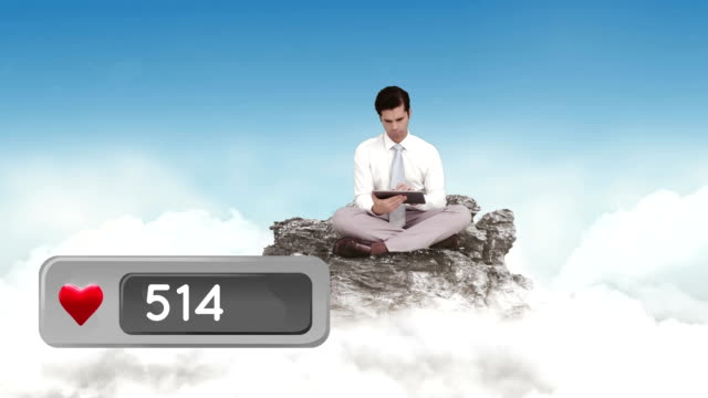 Man-sitting-on-a-rock-above-the-clouds