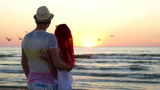 Young-beautiful-couple-kissing-at-twilight-on-the-beach