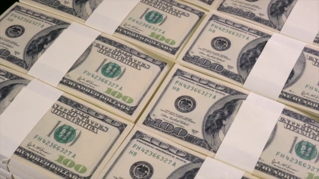 Stacks-of-US-dollars-in-hundred-dollar-banknotes.