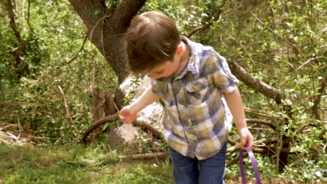 Boy-holding-an-Easter-basket-walks-towards-his-mother-holding-a-white-basket