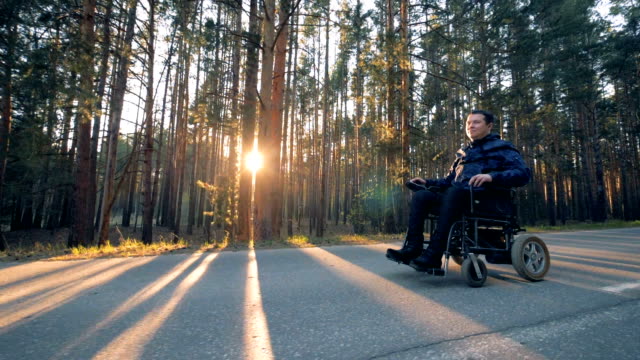 Moving-process-of-a-handicapped-person-in-a-wheelchair-outdoors