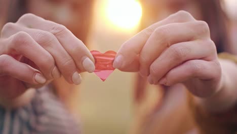 Human-hand-holding-heart-shaped-confetti